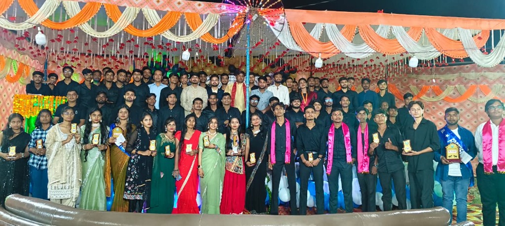 Awards ceremony group photo with trophies on decorated stage