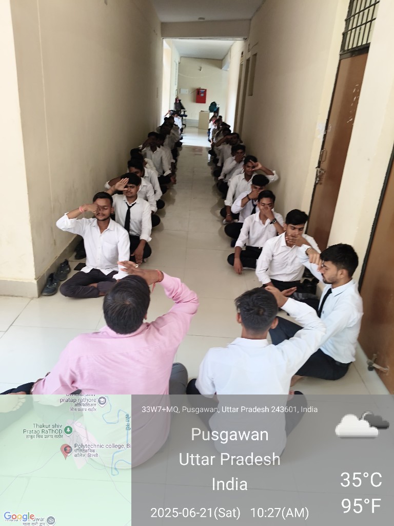 Two rows of students performing alternate nostril breathing during International Yoga Day celebrations
