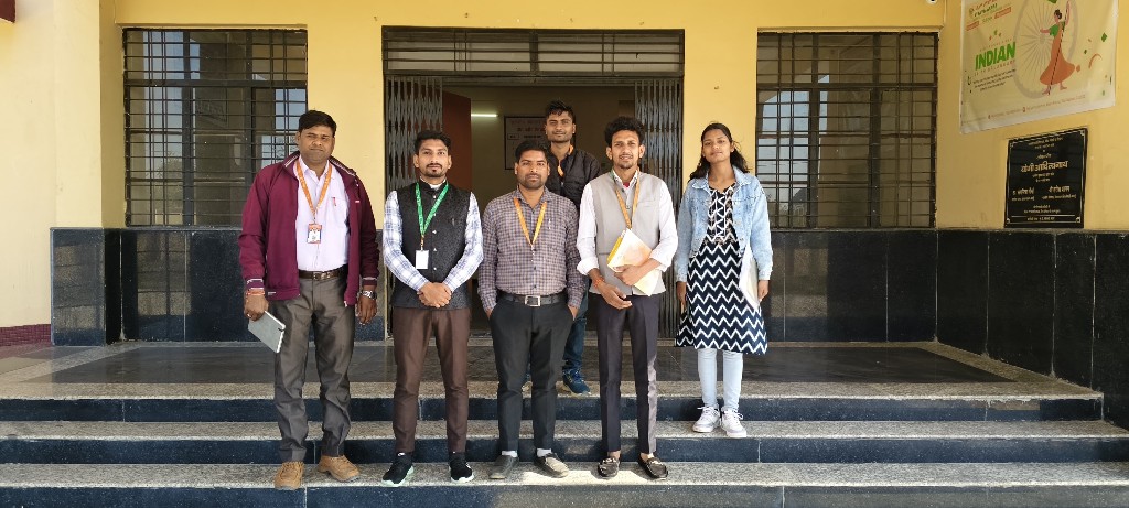 Staff and faculty group photo at the main building entrance of Government Polytechnic Bilsi